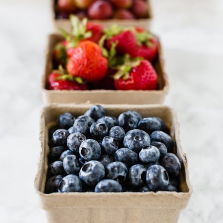 Cartons of fresh fruit ready for smoothie making.