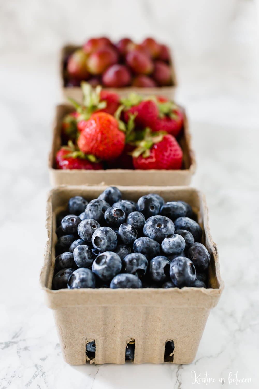 Cartons of fresh fruit ready for smoothie making.