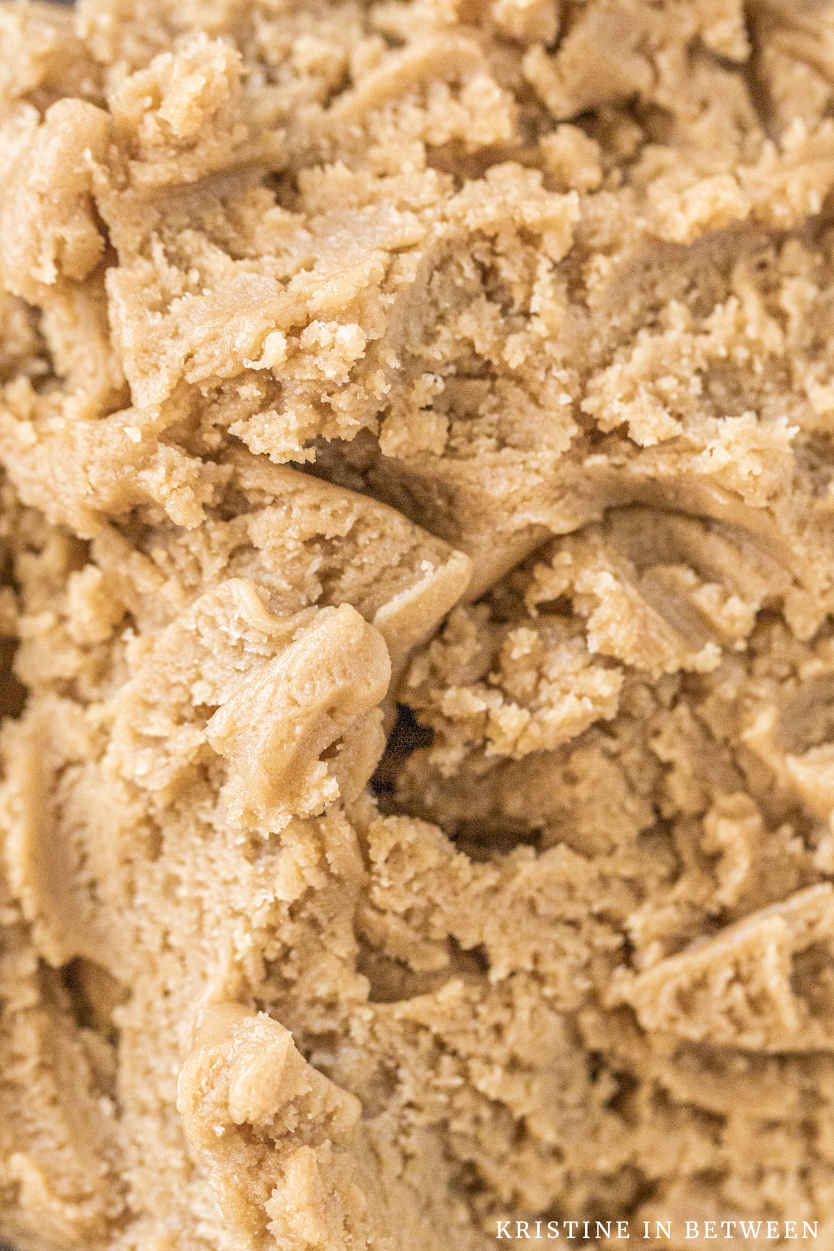 A closeup of cookie dough, showing the texture of the dough.