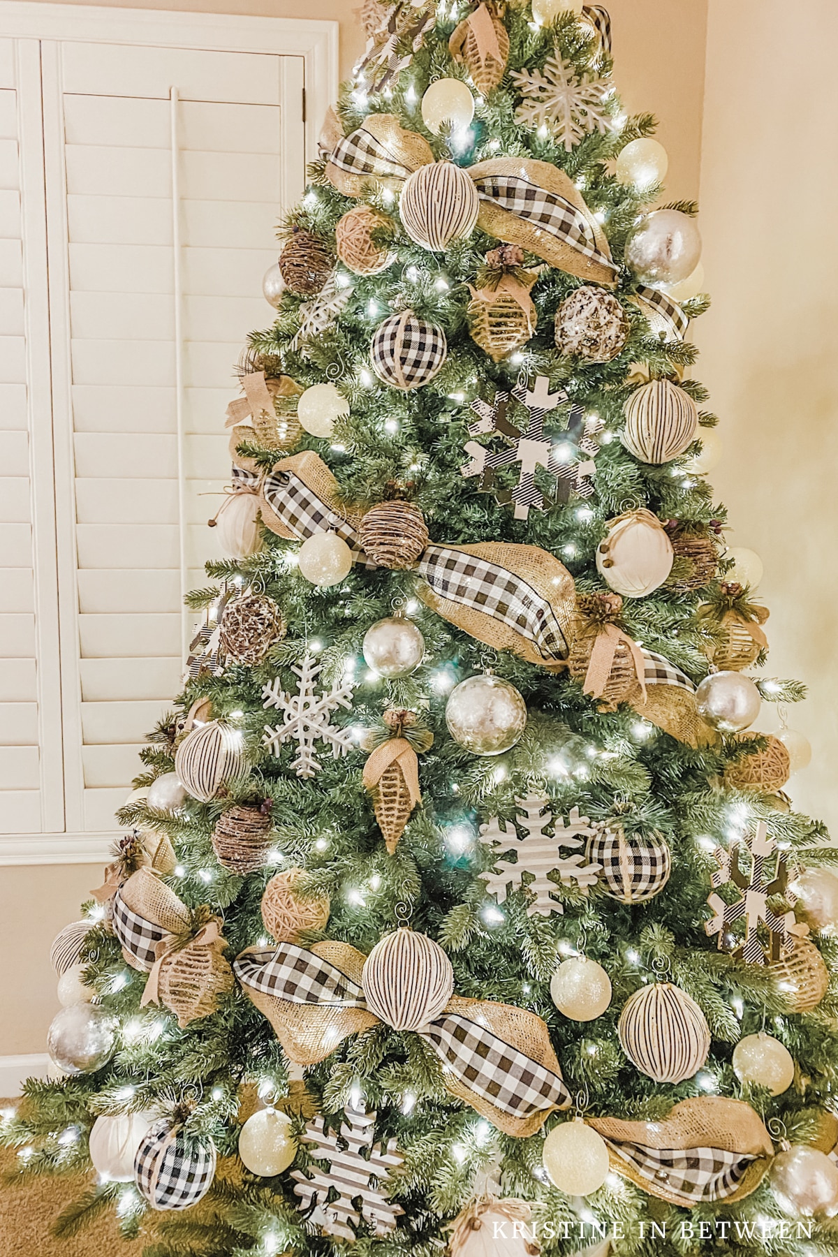 A Christmas tree decorated in burlap, black and white.