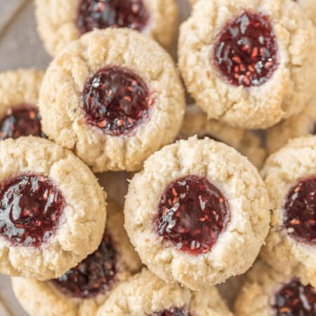 Cookies piled up on a tin plate.