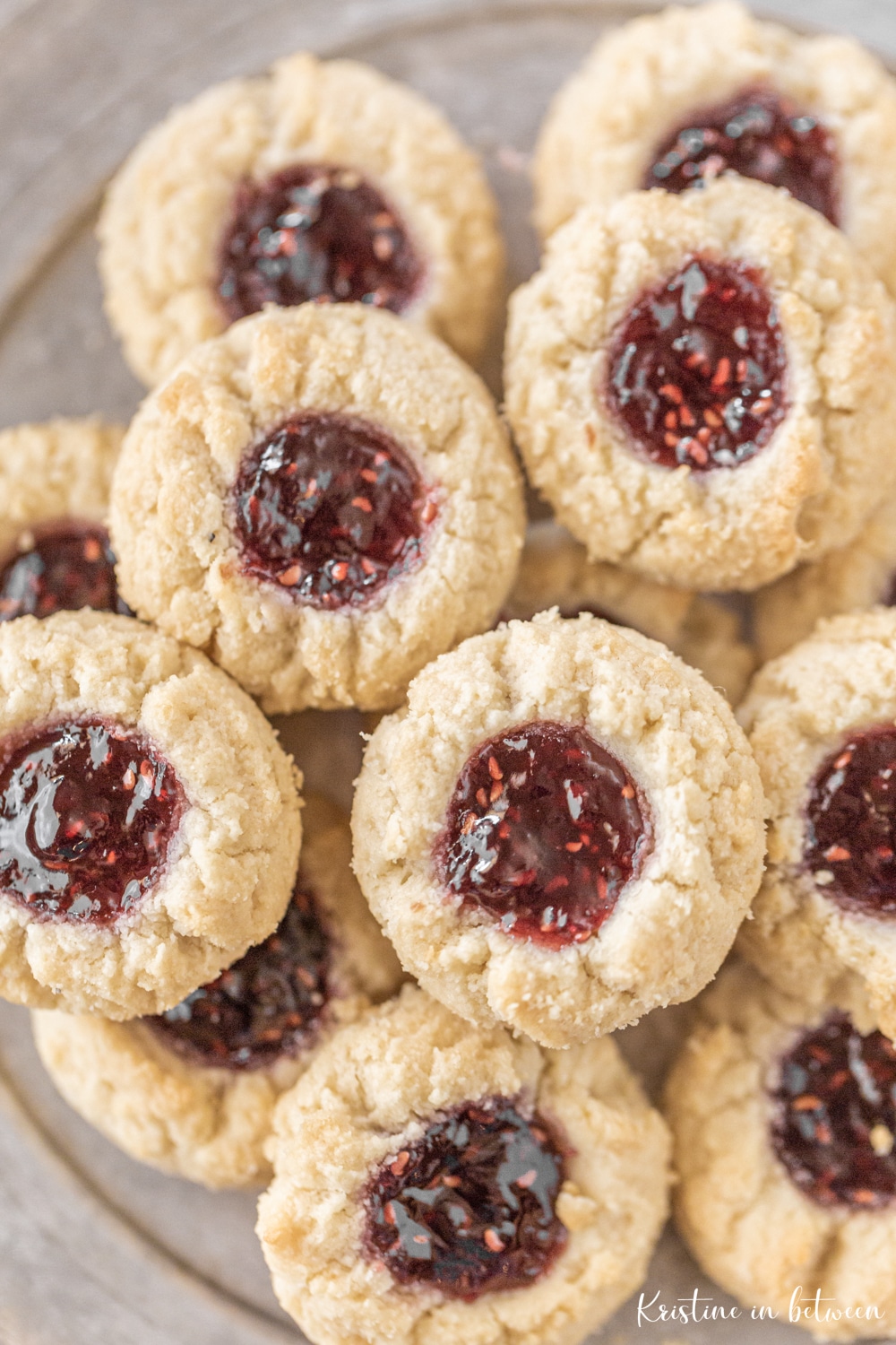 Shortbread cookies stacked up on a tin plate.
