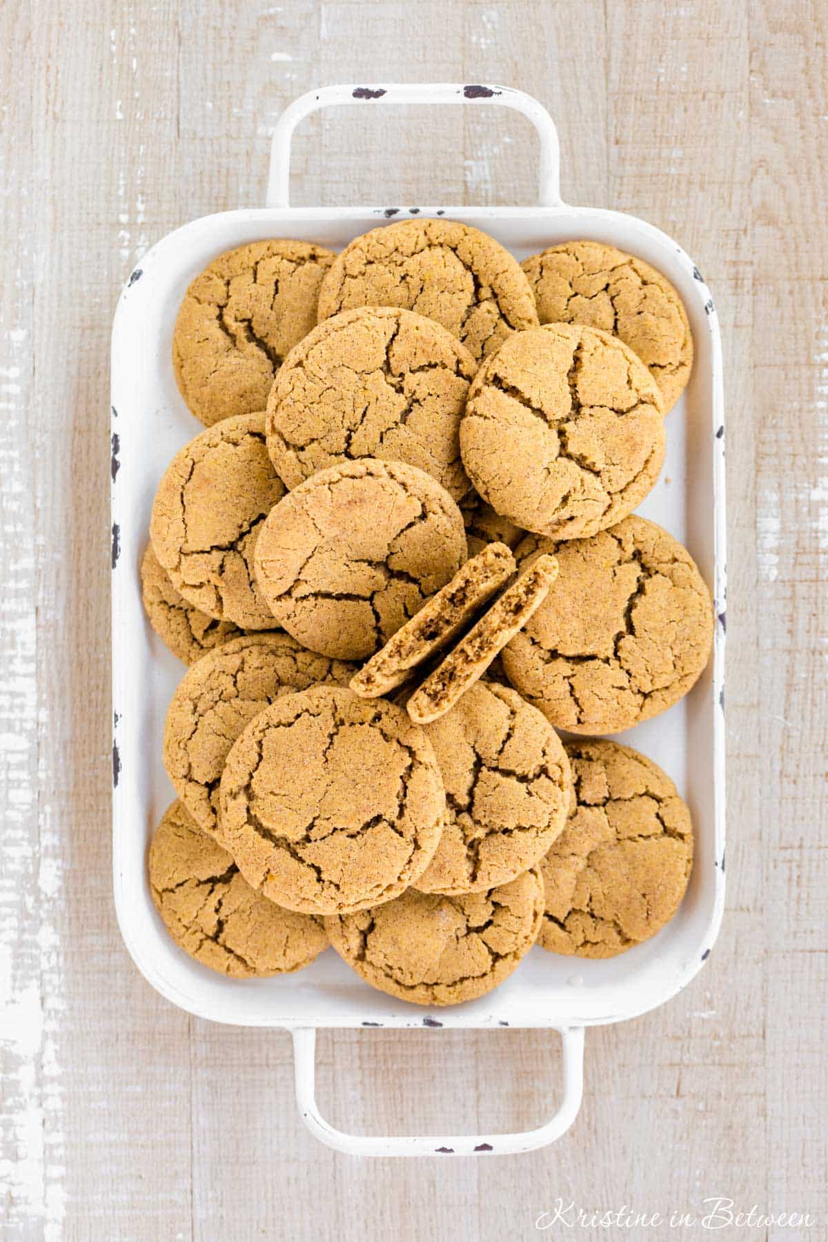 A tray of pumpkin cookies all stacked up.