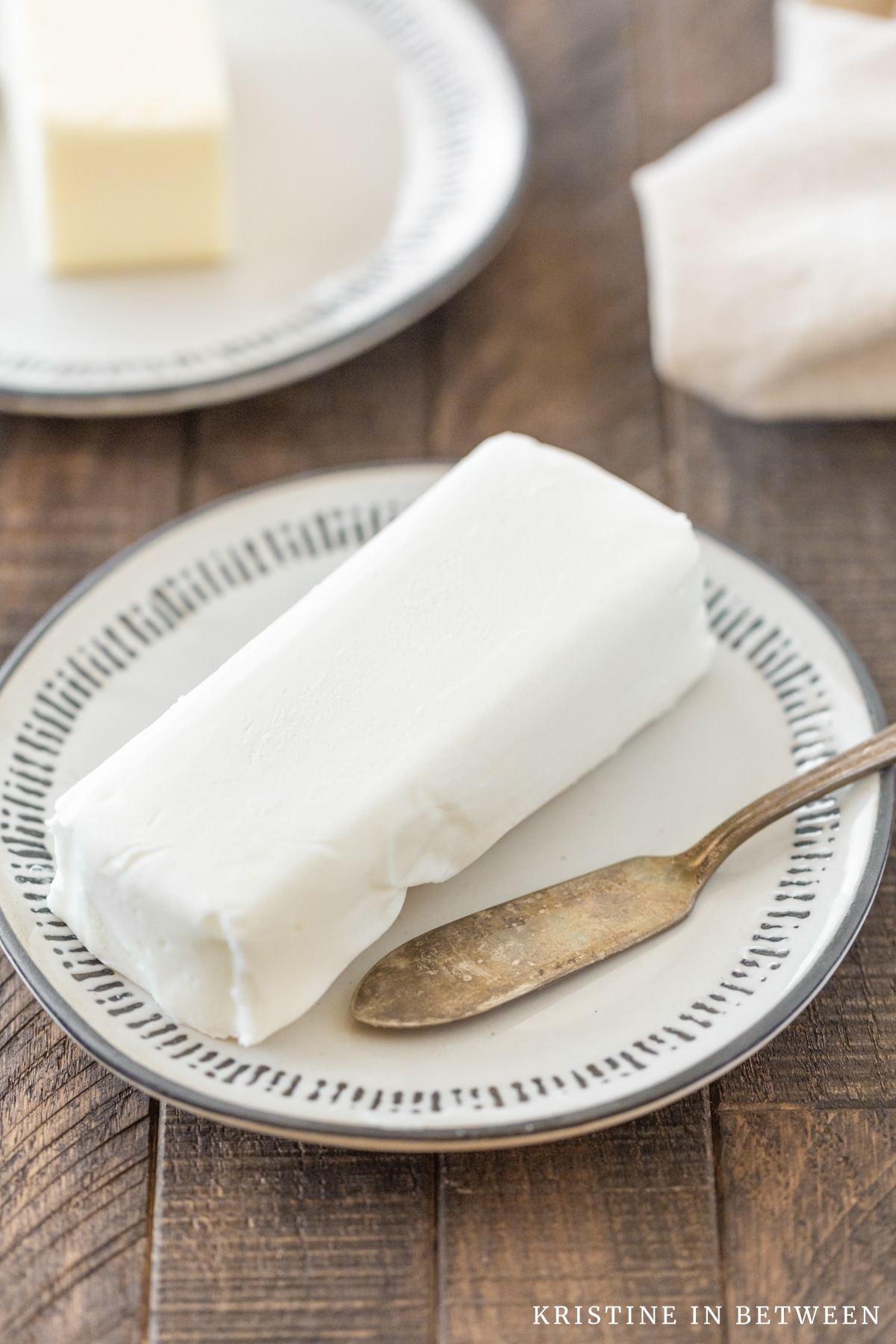 A plate of shortening sitting with a butter knife.