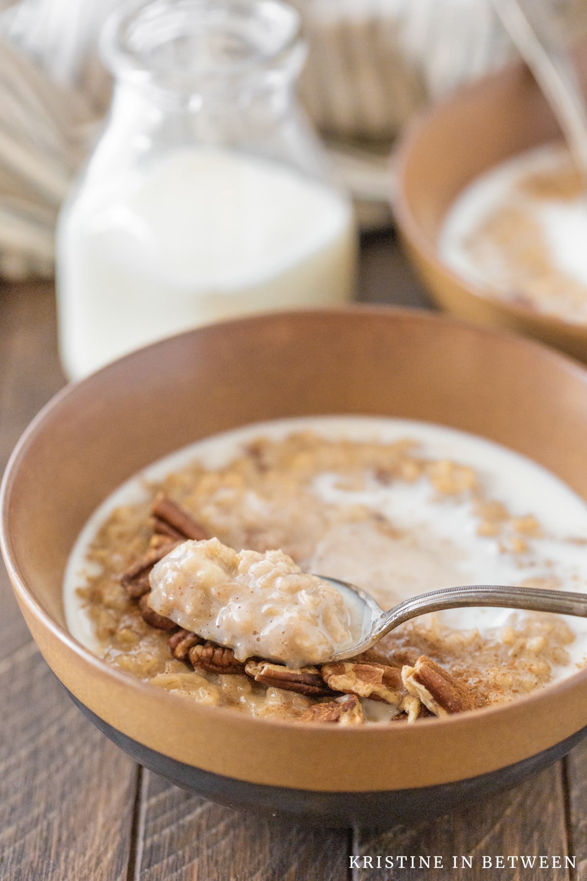Banana pecan oatmeal in a bowl with a spoon.
