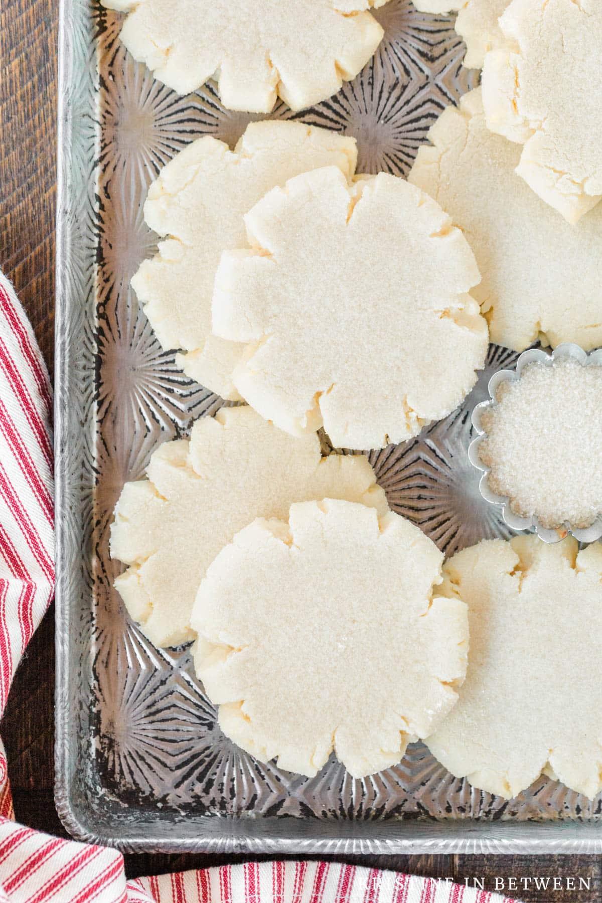 Cookies laying on an old cookie sheet with an old spatula.
