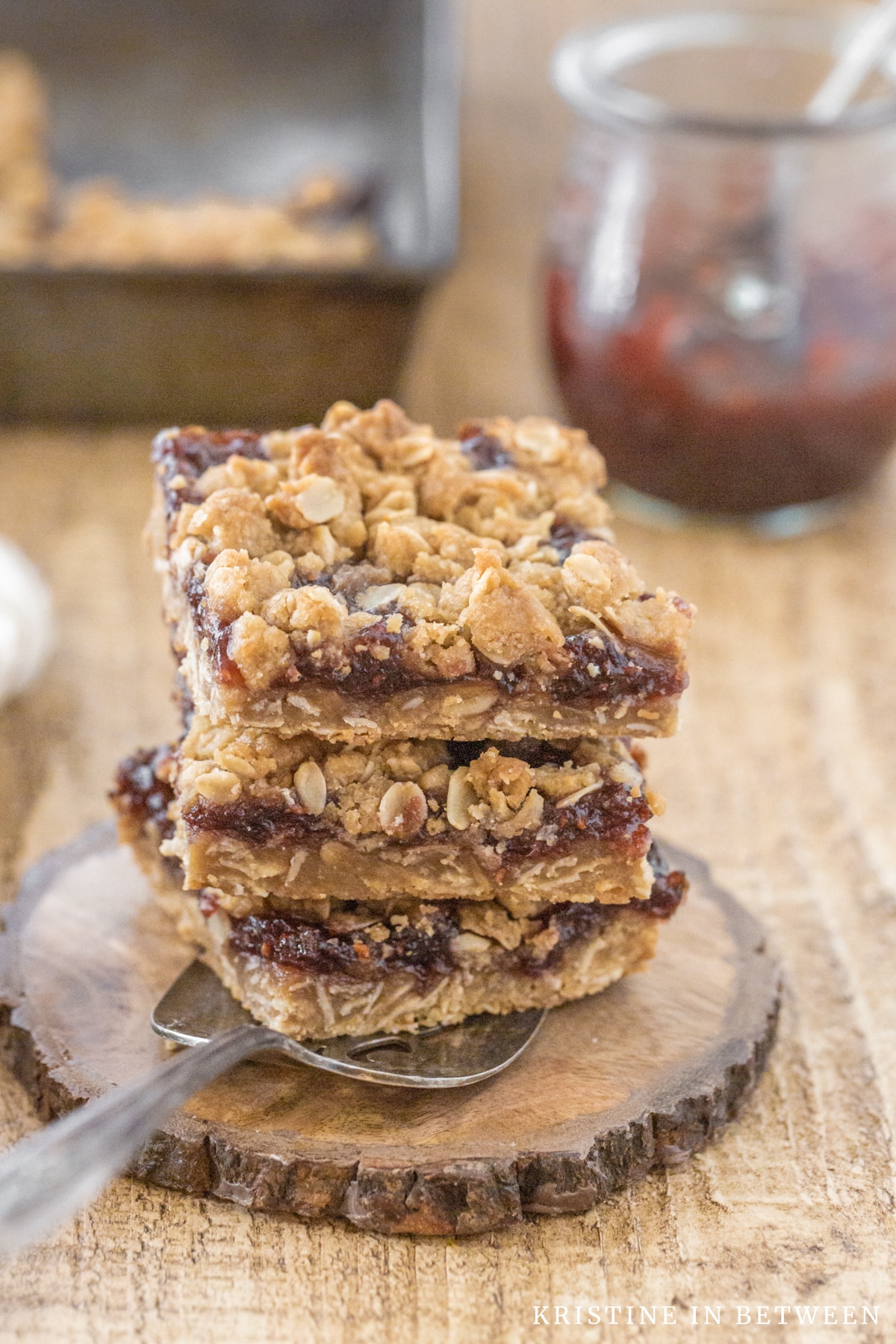 Jam bars cut in squares stacked up on antique spatula.