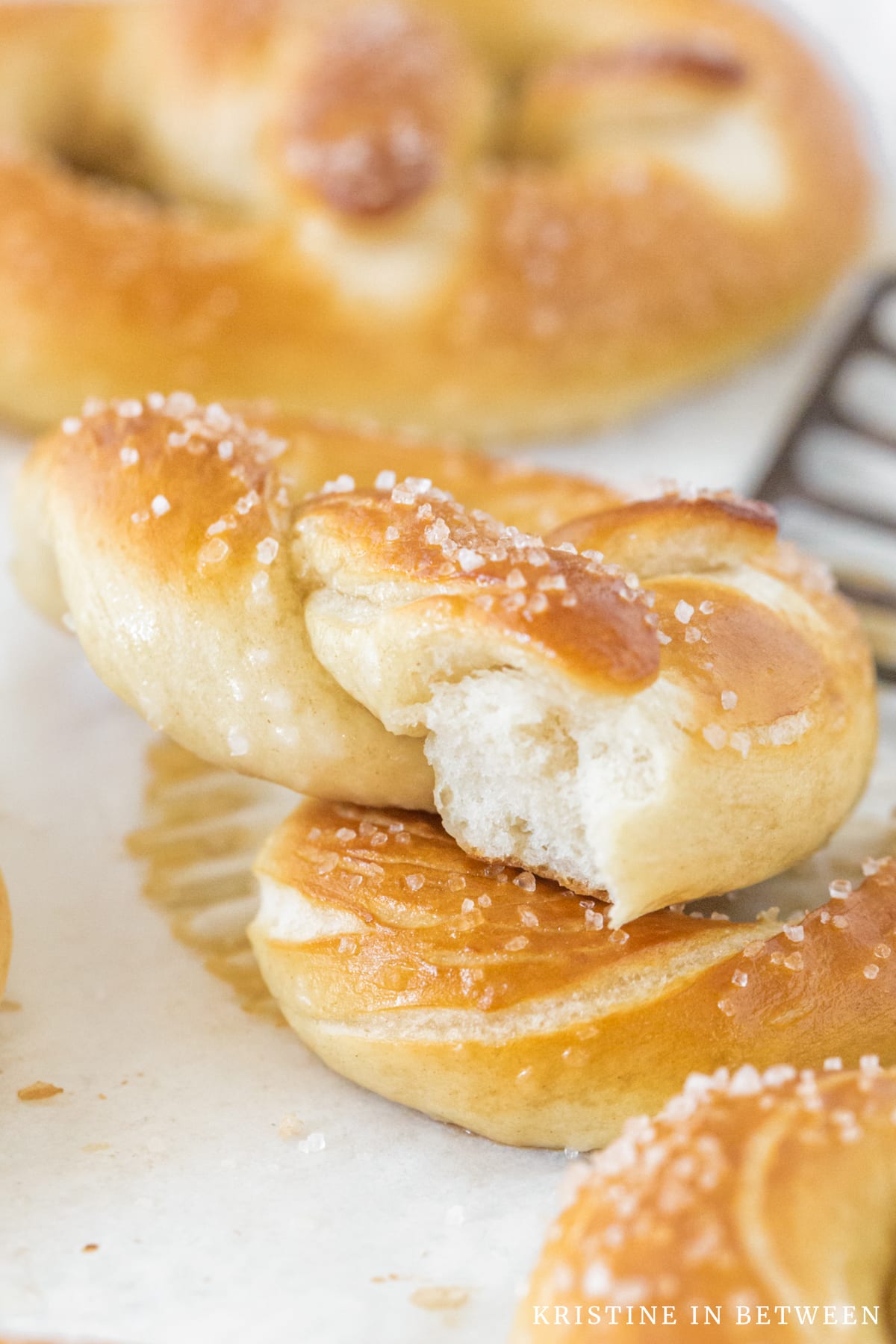 A soft pretzel torn in half to show the inside detail.