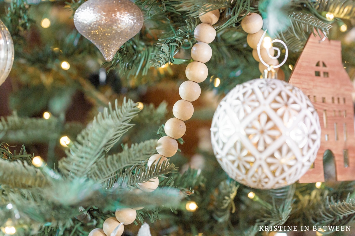 A minimally decorated Christmas tree with neutral colors.