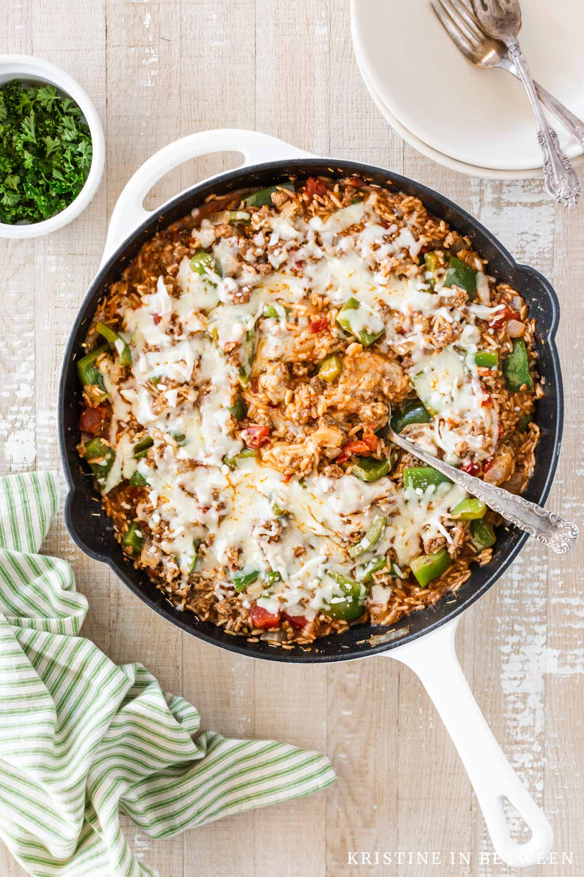 A pan of stuffed pepper skillet with a spoon in the center.