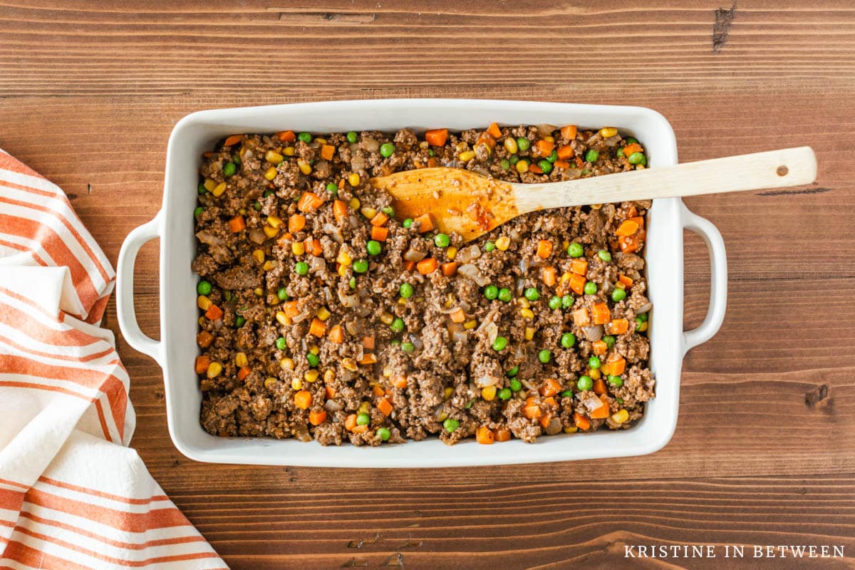 Meat layer of shepherd's pie with peas, corn, and carrots.