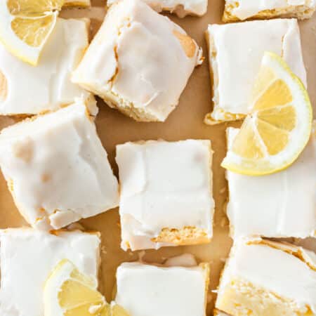 Sliced lemonies laying on parchment paper with sliced lemons on top.