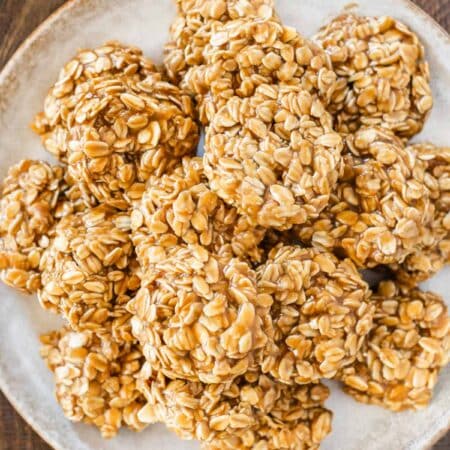 Cookie butter no-bake cookies piled up on a white plate.