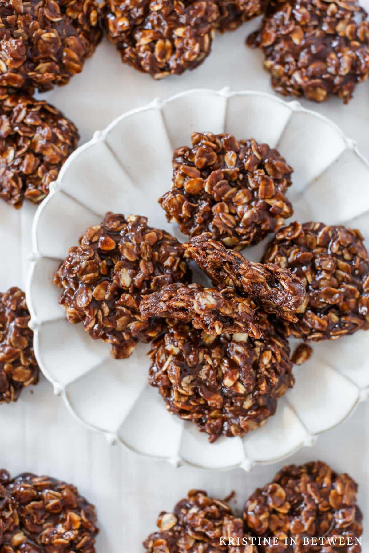 A bunch of no-bake cookies on a white plate.