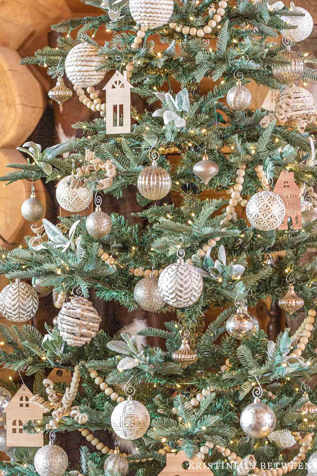 A minimally decorated Christmas tree with neutral colors.