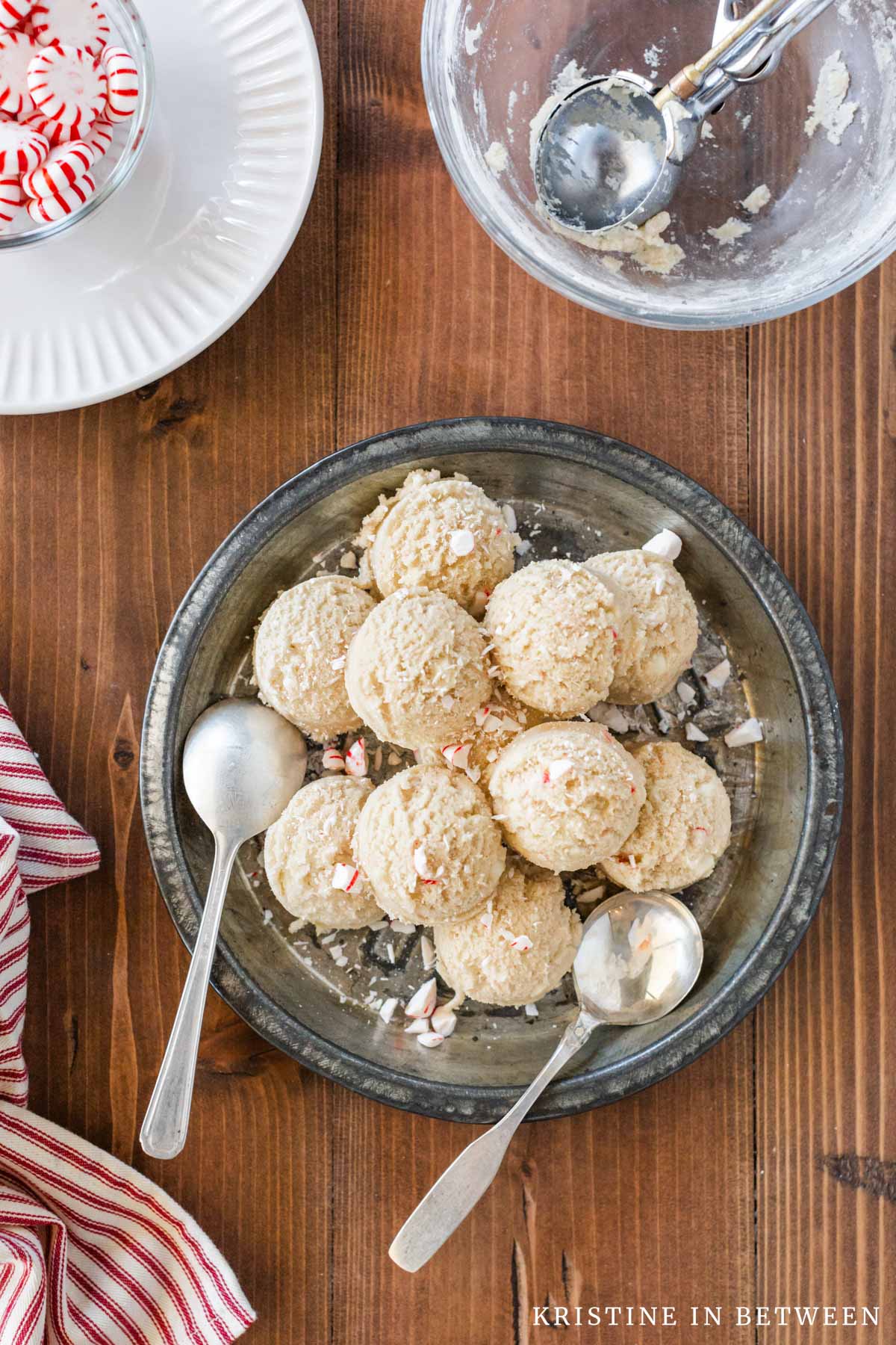 Edible peppermint cookie dough scooped out onto an antique pie plate with two spoons.