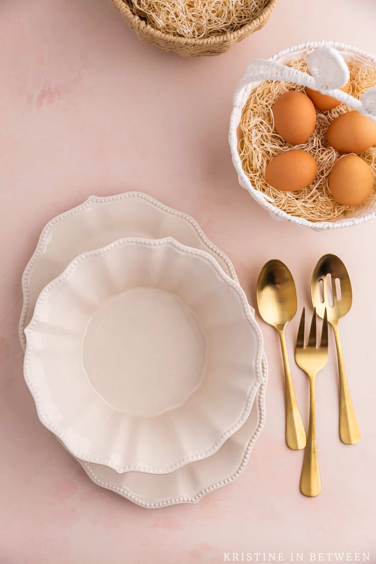 Holiday preparation for Easter dinner with the serving dishes and serving utensils laying out next to easter baskets.
