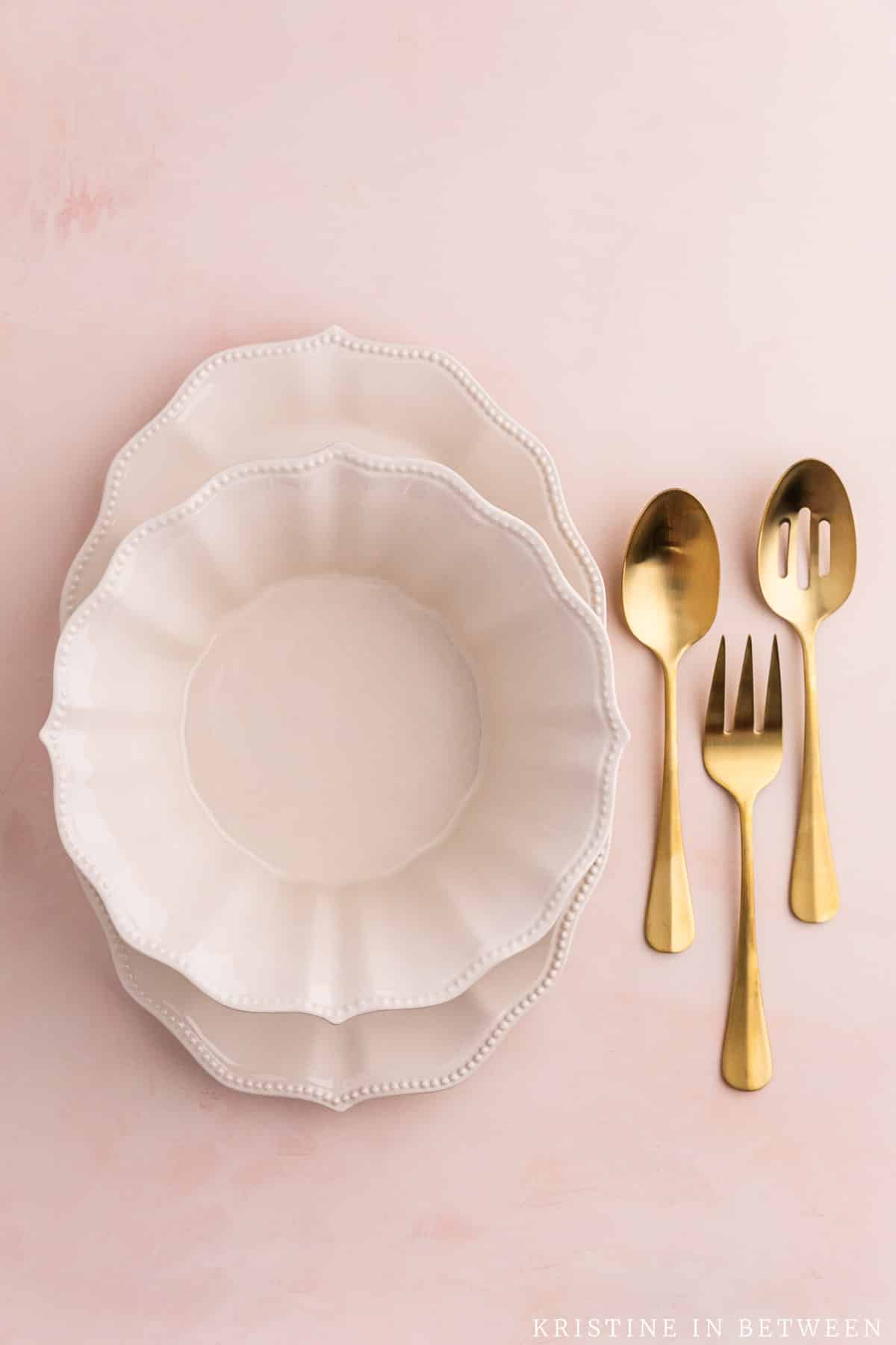Holiday preparation for Easter with serving dishes and serving utensils laid out.