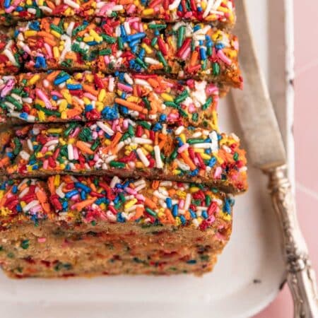 Slices of sugar cookie banana bread laying on a white tray.