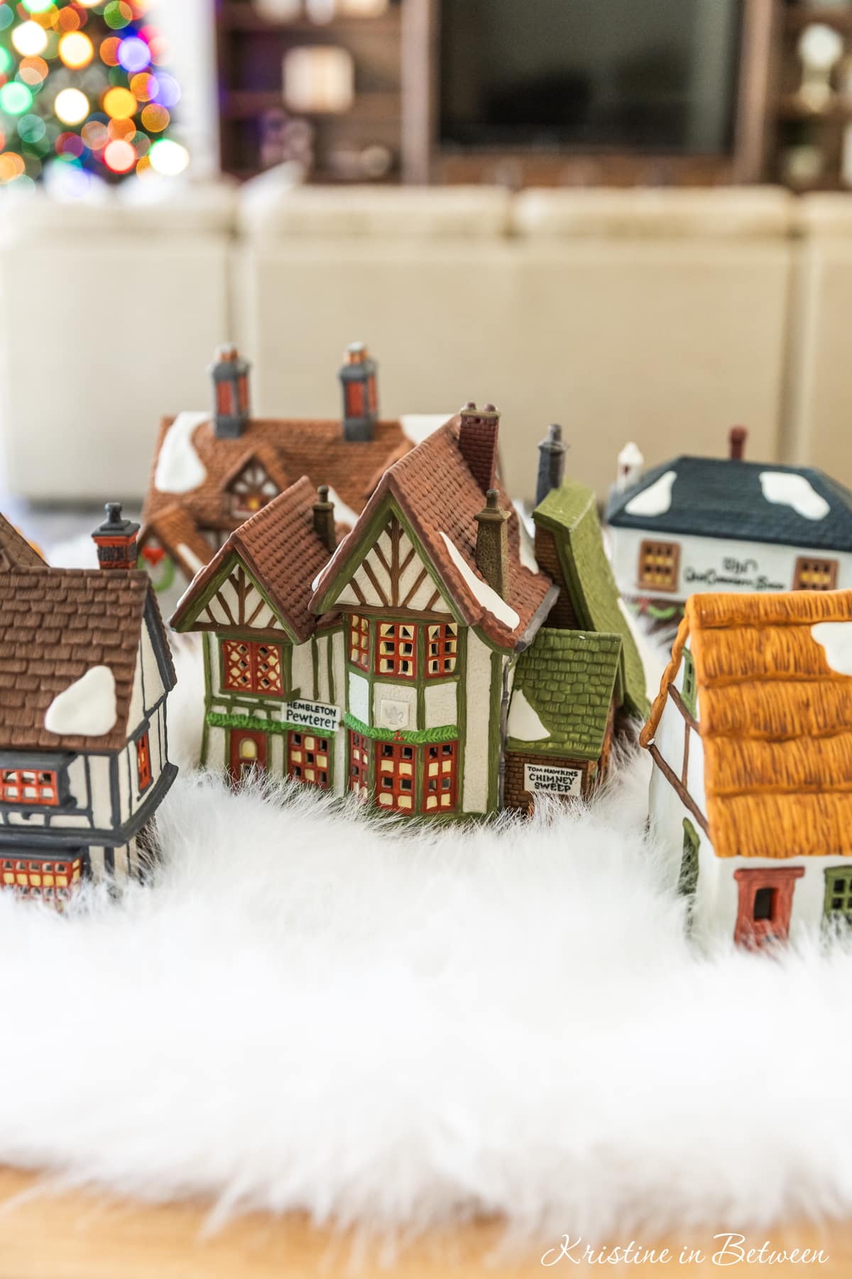 Houses from a Christmas villages sitting on a table ready to be set up.