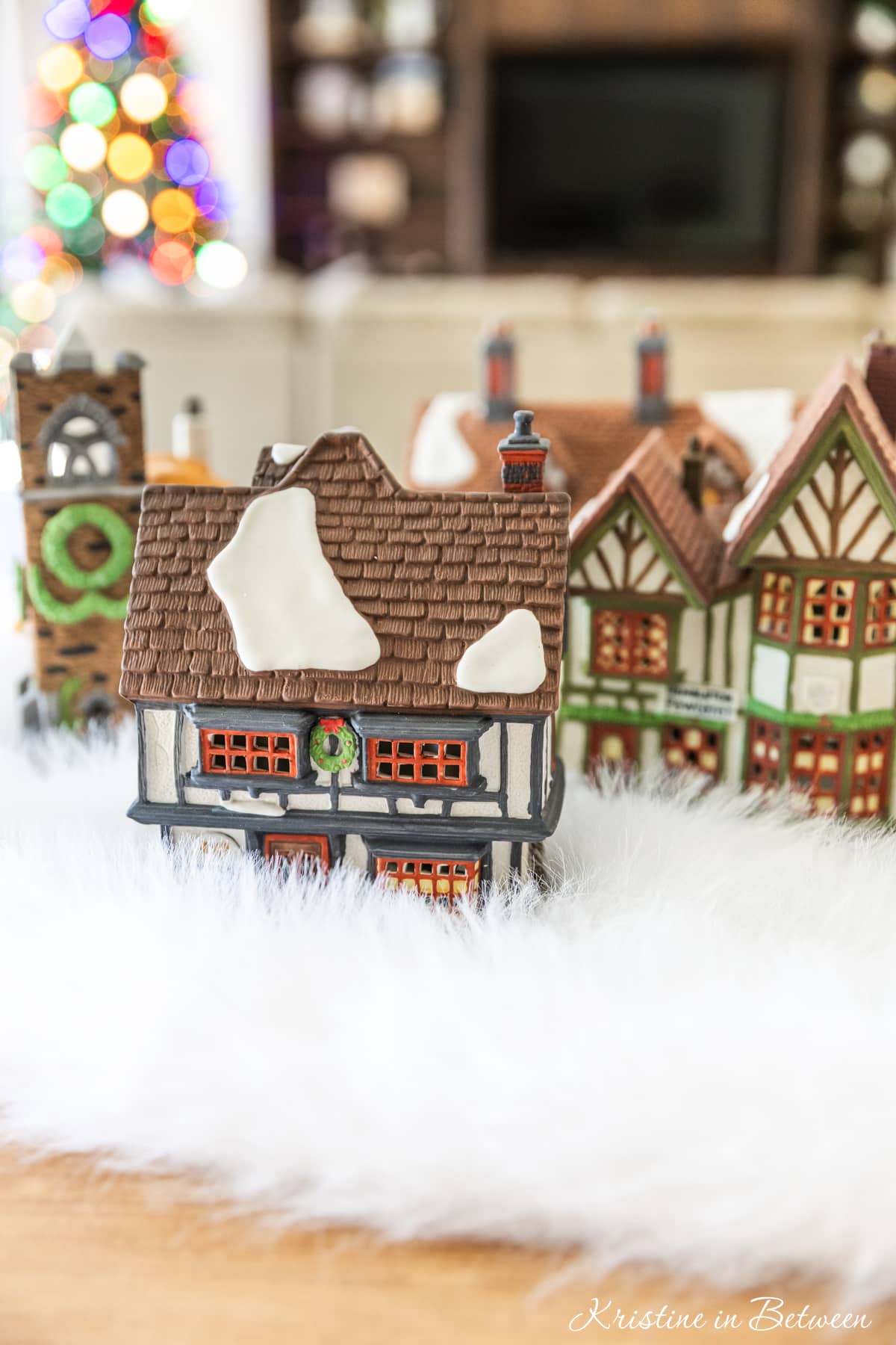 Houses from a Christmas villages sitting on a table ready to be set up.