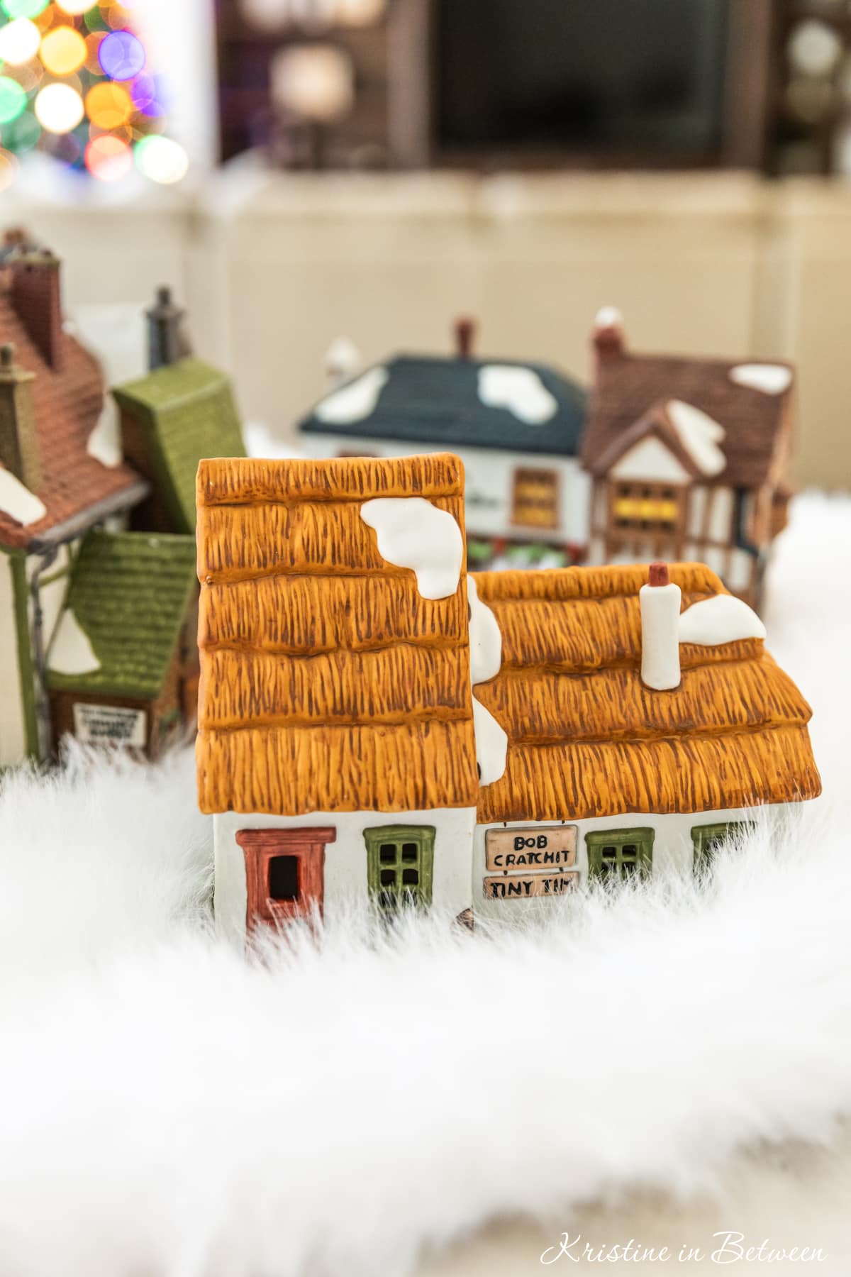Houses from a Christmas villages sitting on a table ready to be set up.