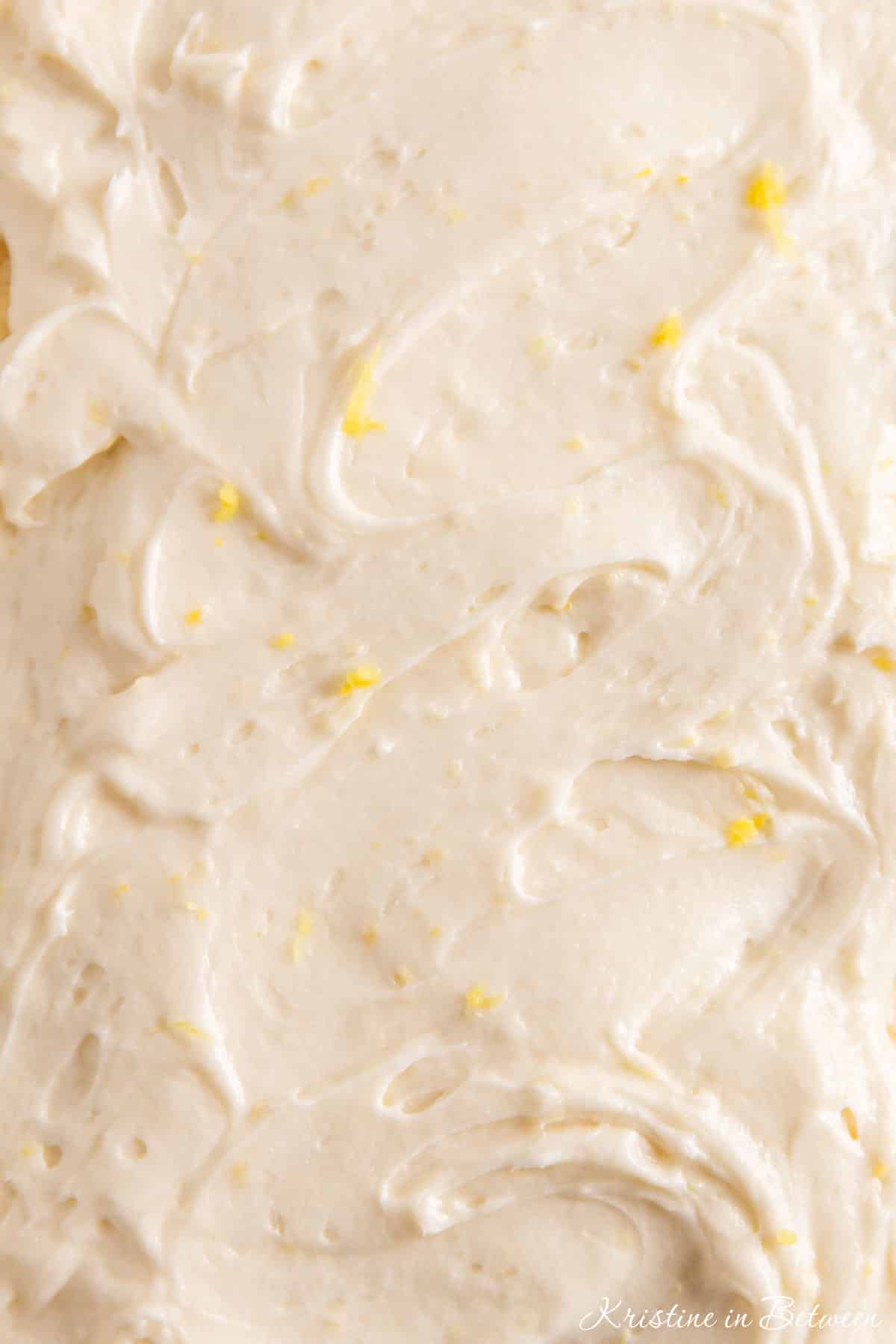 Lemon buttercream frosting sprinkled with lemon zest.