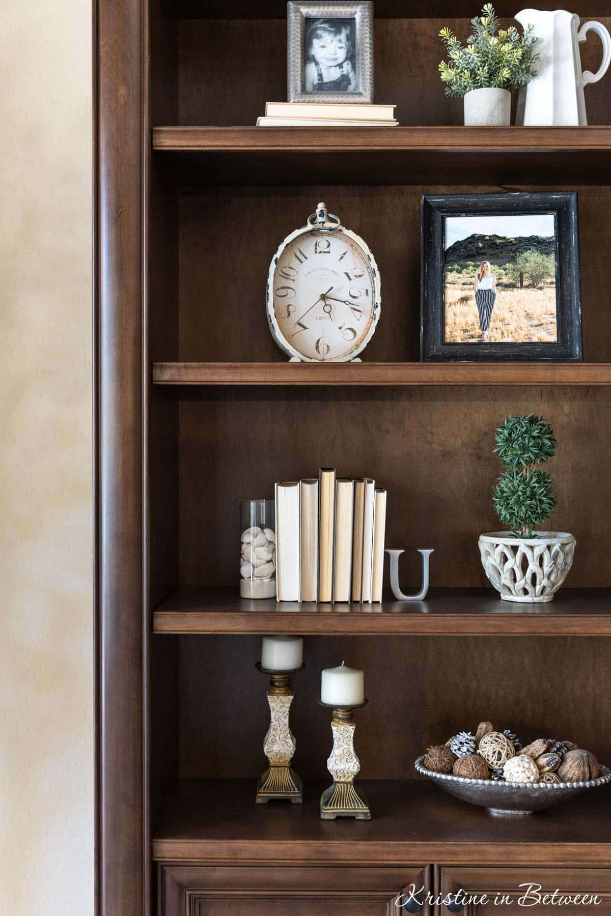 Bookshelves with books and farmhouse decor sitting on them.